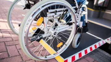 Person mit Rollstuhl auf einer Niederflurrampe beim Einstieg in einen regiobus